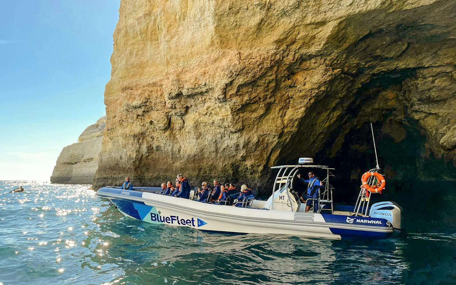 Tourists on a speedboat tour near Benagil Cave, Algarve coast.