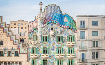 Casa Batlló facade with colorful mosaic tiles in Barcelona.