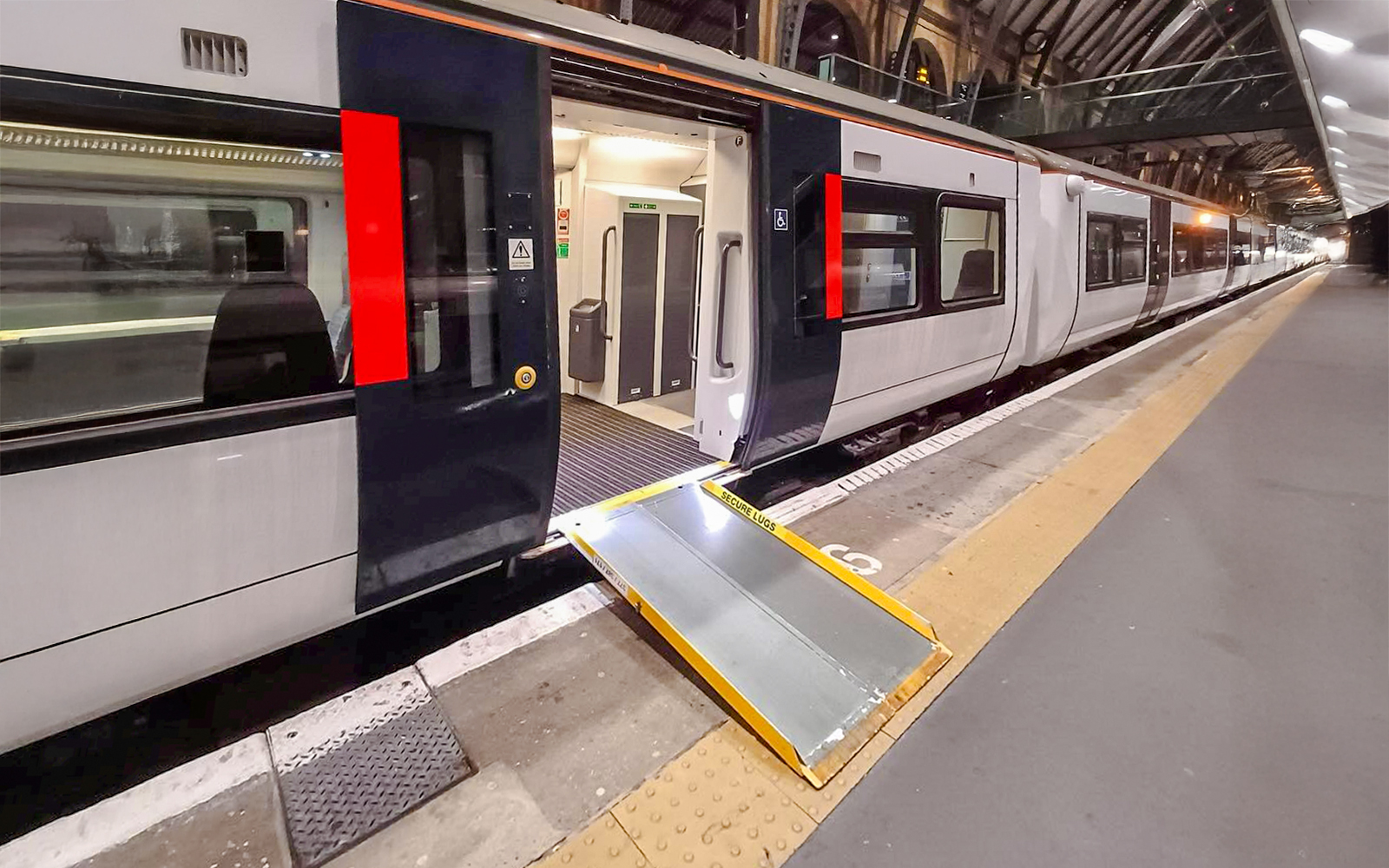 Train at platform with accessibility ramp, London St Pancras International.