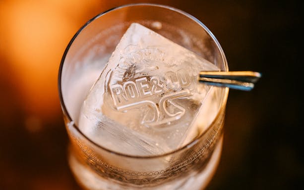 Roe & Co Distillery logo on ice cube in a glass.