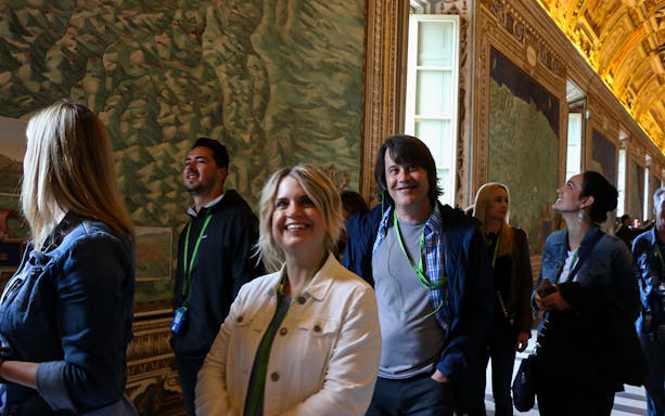 Tourists exploring the Gallery of Maps in the Vatican Museums.