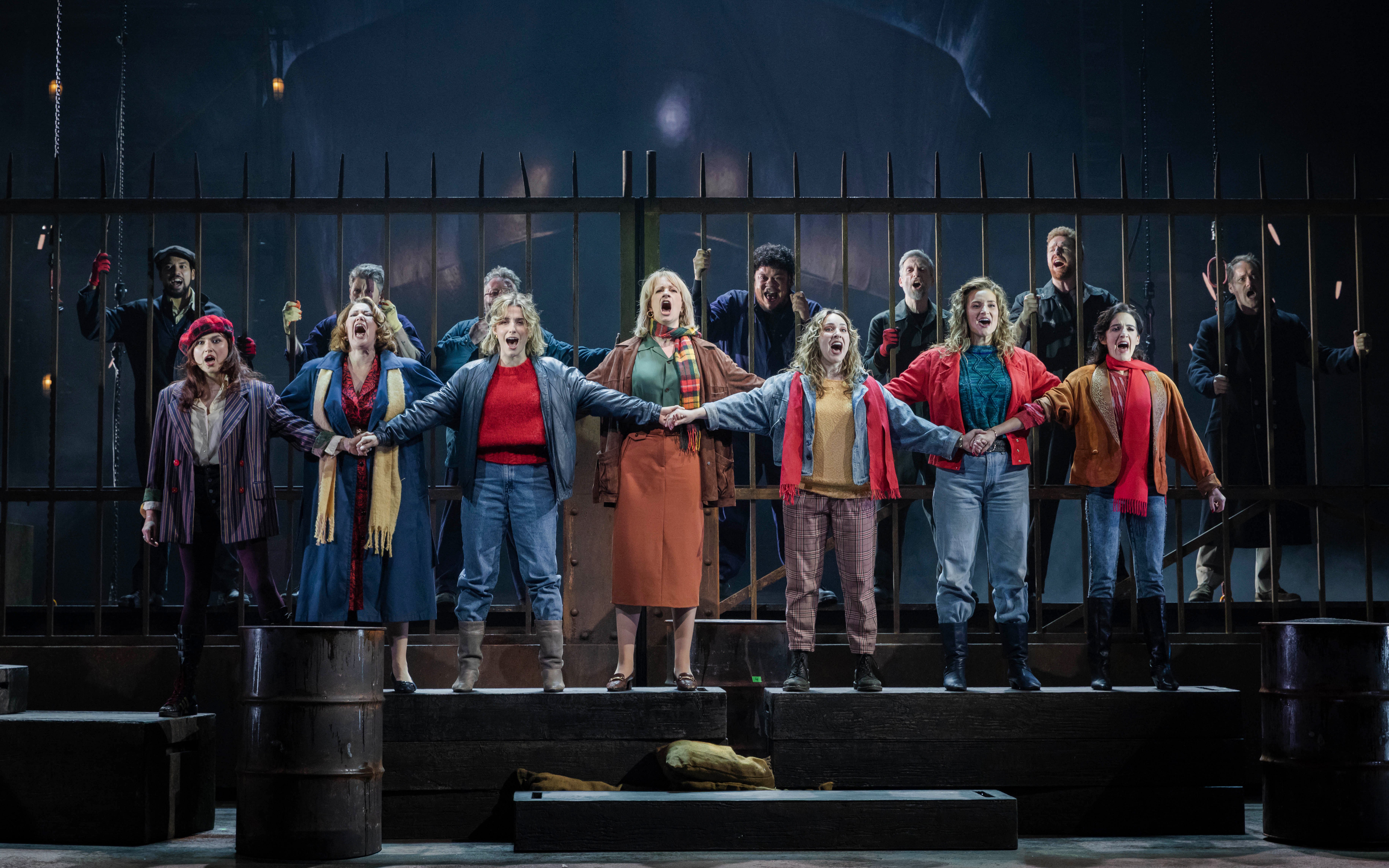 Stage performance of "The Last Ship" in Brisbane with actors singing in unison.