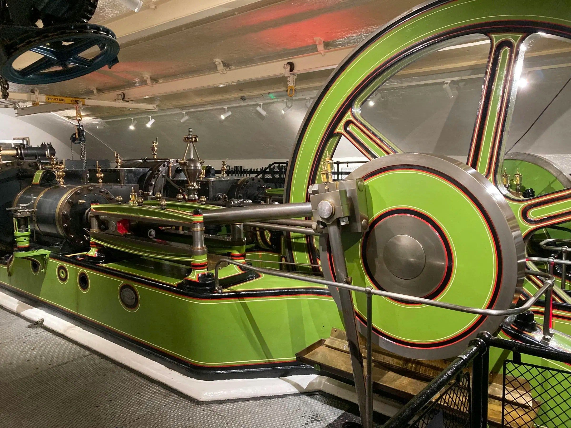 Tower Bridge engine room with large green and red machinery components.