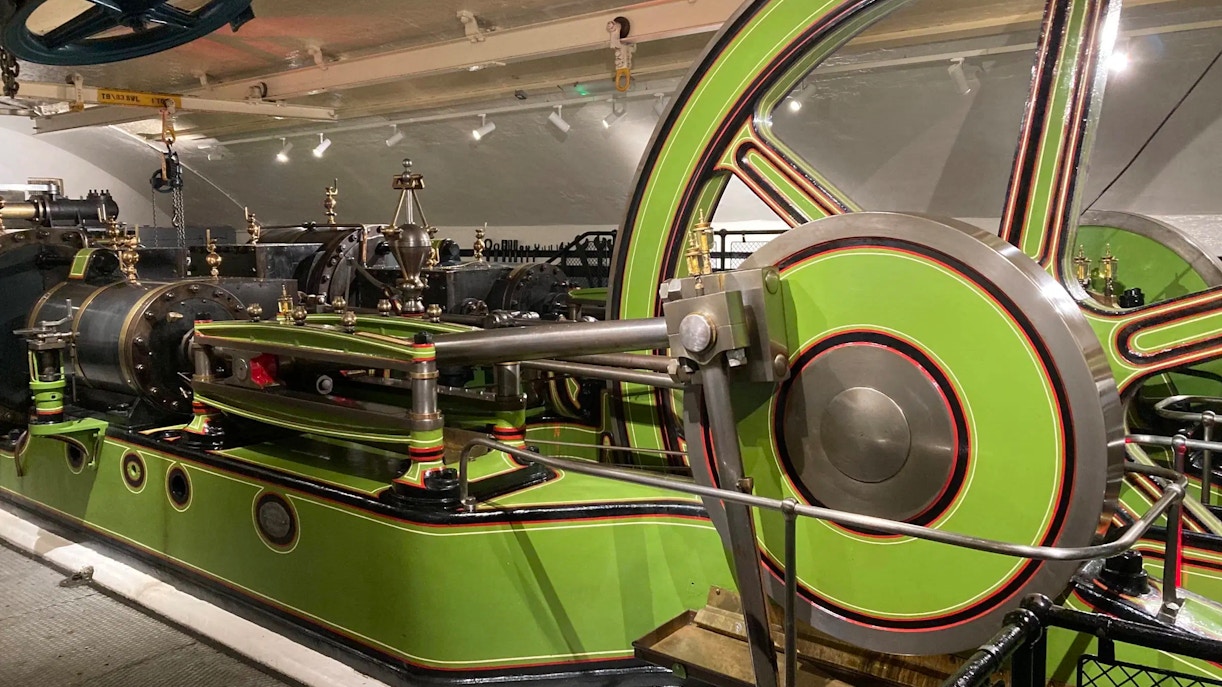 Tower Bridge engine room with large green and red machinery components.