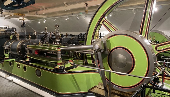 Tower Bridge engine room with large green and red machinery components.