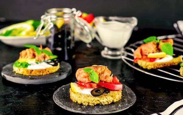 Open-faced sandwich with salmon, olives, and basil at Café Wintergarten breakfast.