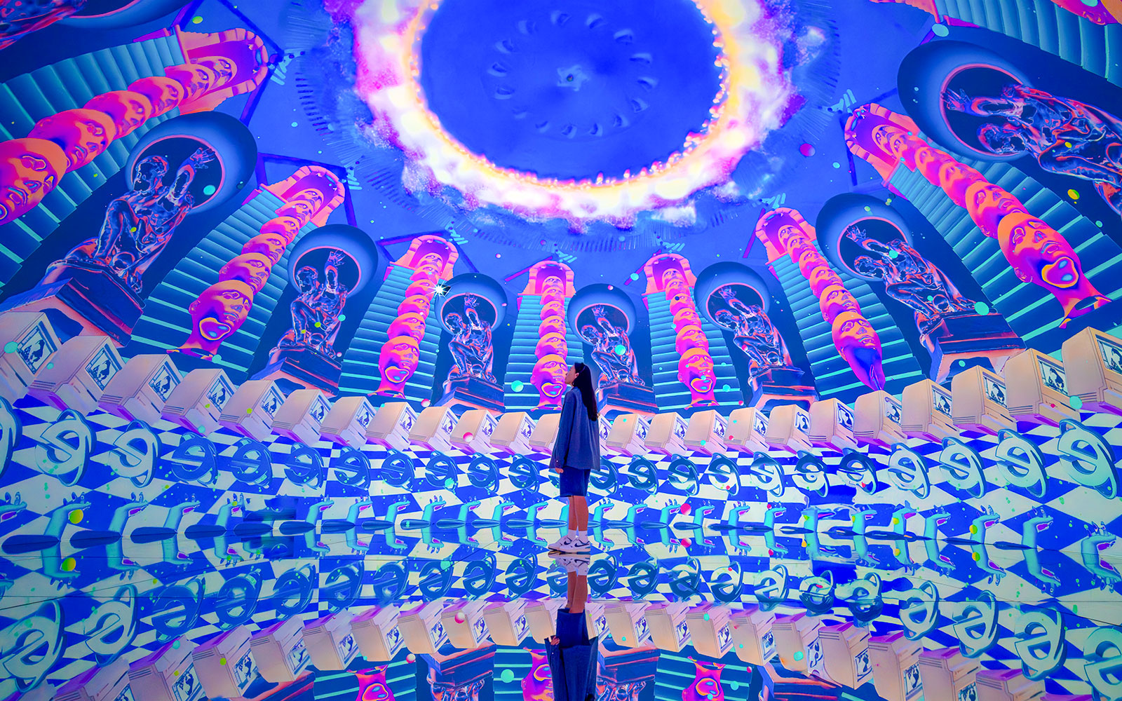 Tourist exploring vibrant digital art installation at House of Hype, Dubai.