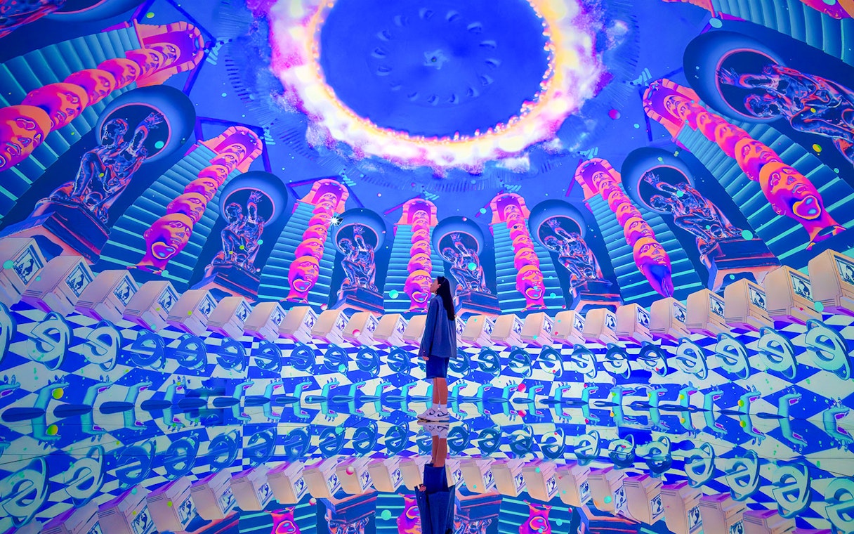 Tourist exploring vibrant digital art installation at House of Hype, Dubai.