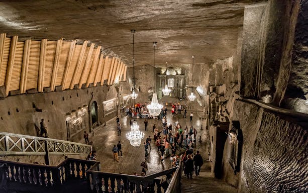 Visitors exploring the illuminated chambers of Wieliczka Salt Mine in Poland.