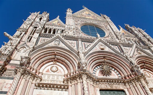 Siena Cathedral facade with intricate Gothic architecture, Italy.