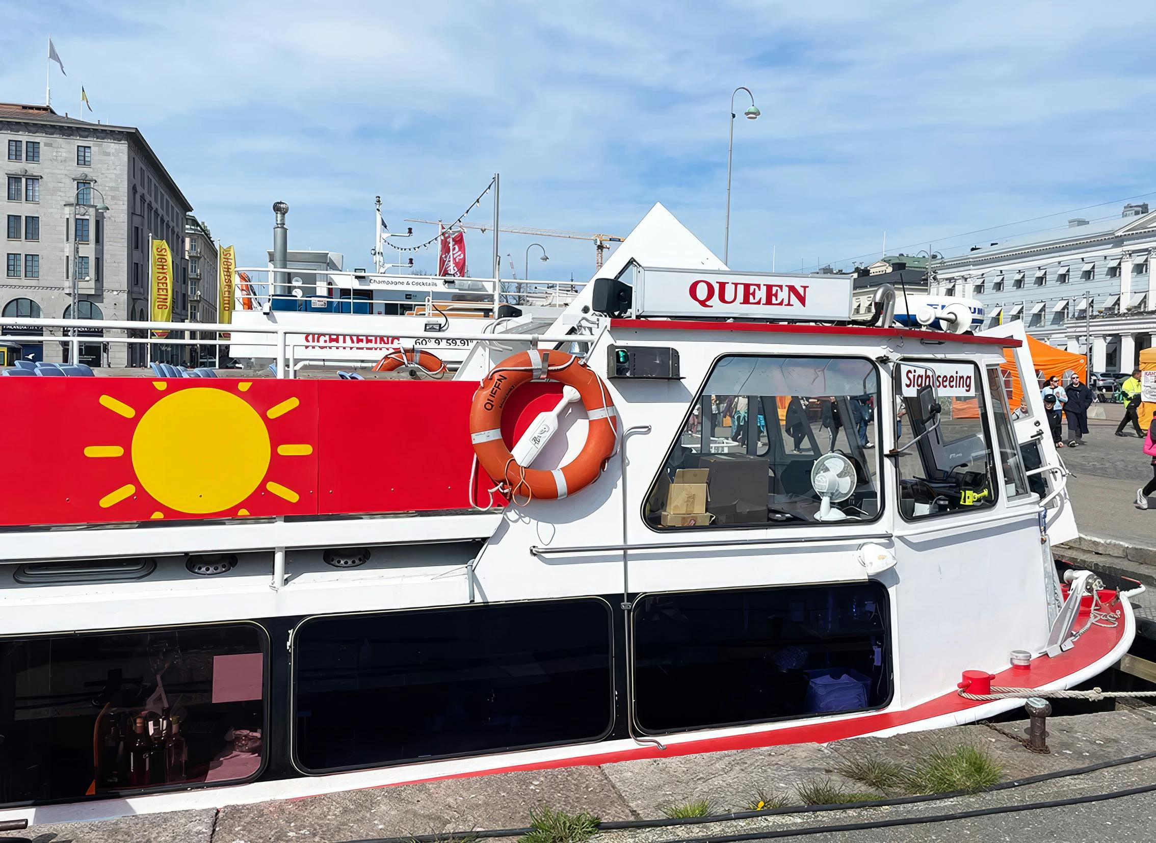 Ship docked at Market Square, Cholera Pool, Finland, with sightseeing signage.