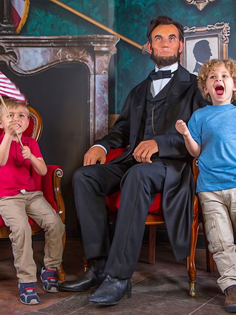 Children with wax figure at Madame Tussaud's, ICON Park Attraction Package.