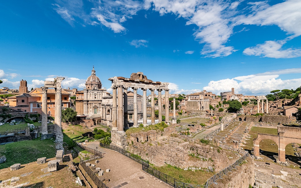 Tourists exploring ruins of Palatine Hill and Roman Forum, Rome, Italy.