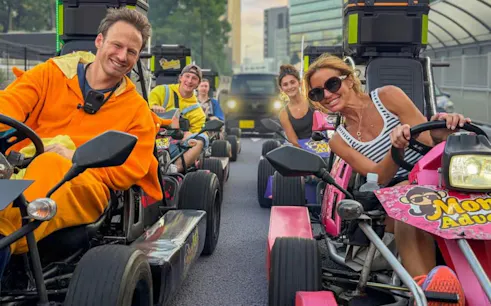Go-kart riders in costumes enjoying Shibuya Crossing 75-min experience by Monkey Kart in Tokyo.