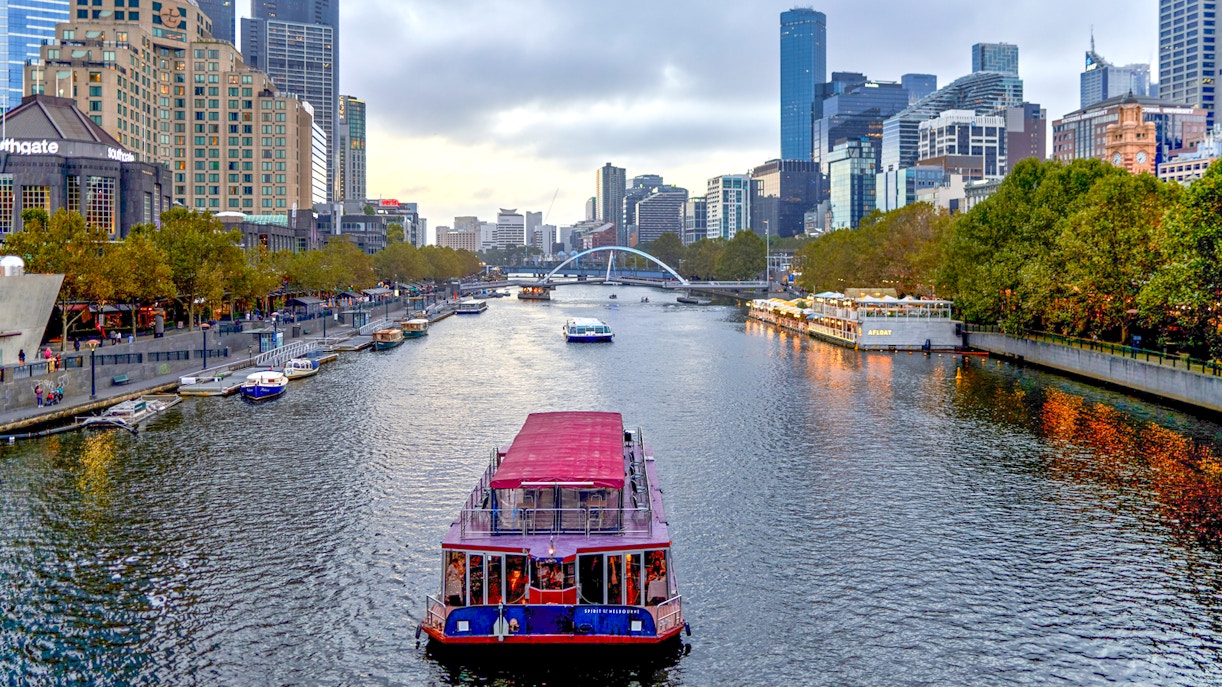 Dinner cruise boat on Yarra River with Melbourne skyline in the background.
