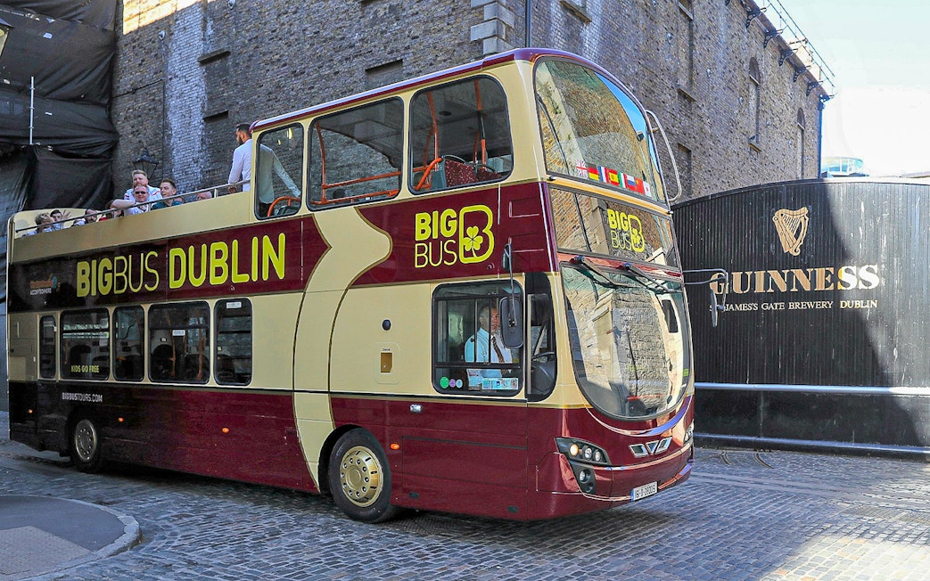 Big Bus Dublin tour passing Guinness Storehouse entrance.