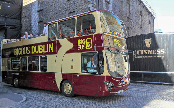 Big Bus Dublin tour passing Guinness Storehouse entrance.