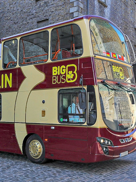 Big Bus Dublin tour passing Guinness Storehouse entrance.