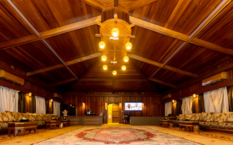 Desert lounge interior with wooden ceiling and traditional seating, part of hot air balloon experience.