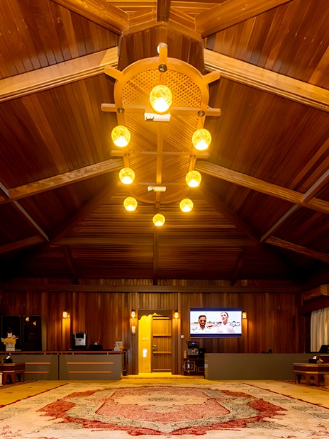 Desert lounge interior with wooden ceiling and traditional seating, part of hot air balloon experience.