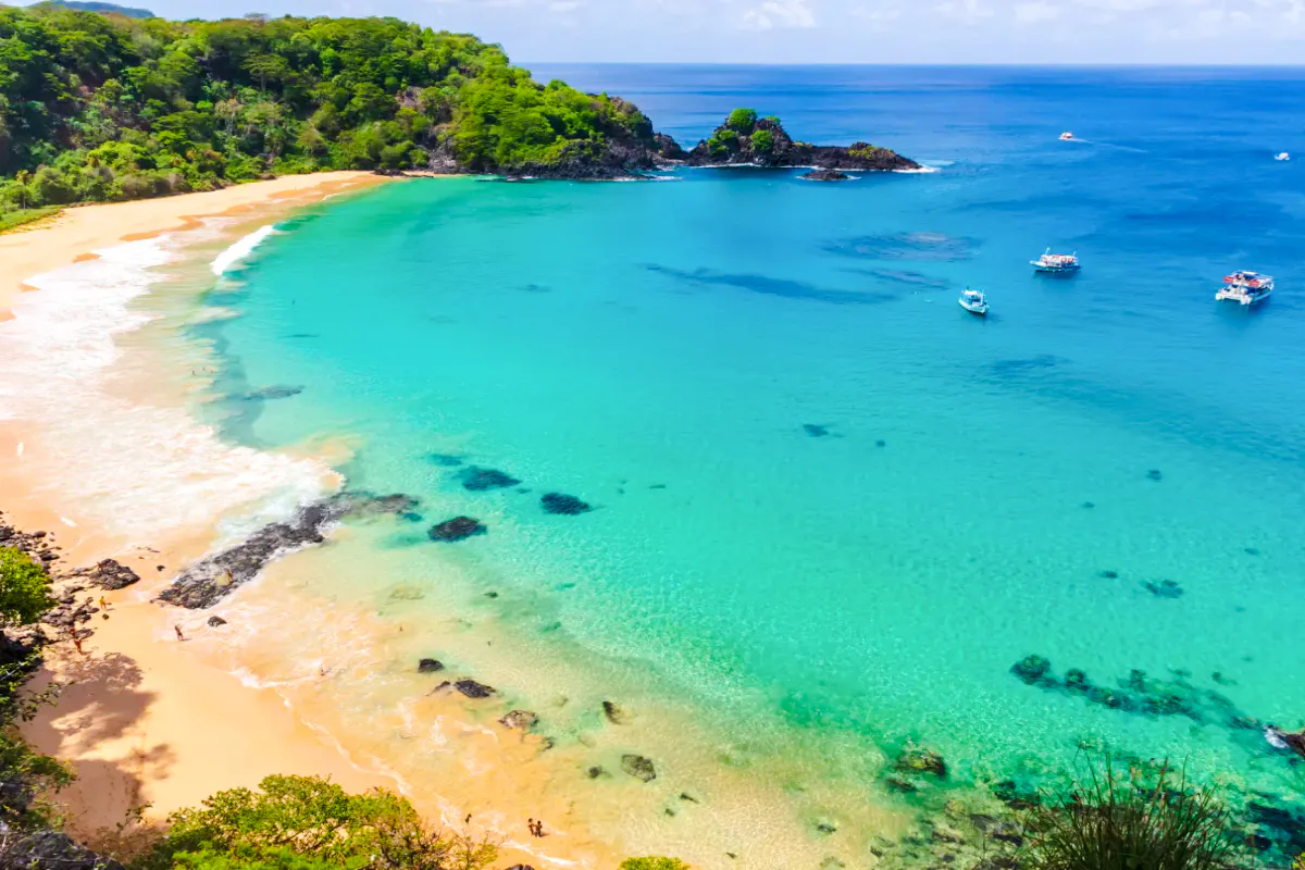 Sancho Beach with boats on turquoise water, Noronha Boat Tour, Sao Paulo.