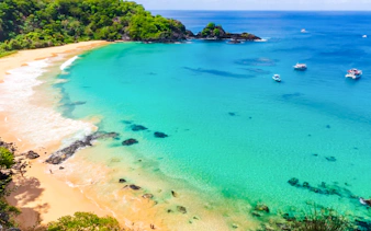 Sancho Beach with boats on turquoise water, Noronha Boat Tour, Sao Paulo.