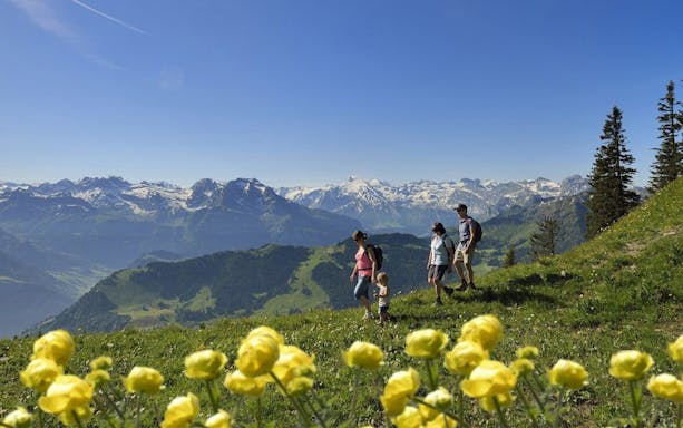 Family hiking on Mount Stanserhorn with views of the Swiss Alps, day trip from Zürich.