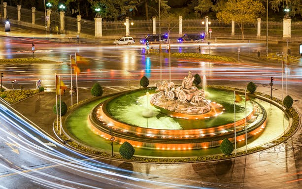 Cibeles Fountain illuminated at night with light trails, Madrid.