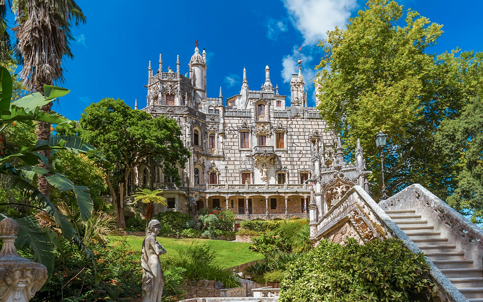 Quinta da Regaleira palace with ornate facade and lush gardens in Sintra, Portugal.