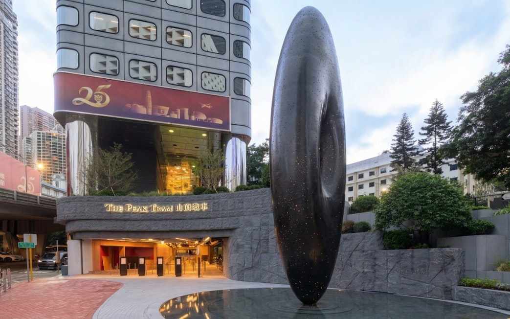 Entrance to The Peak Tram station in Hong Kong with modern sculpture.