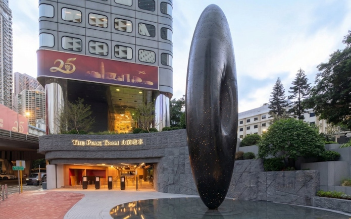 Entrance to The Peak Tram station in Hong Kong with modern sculpture.