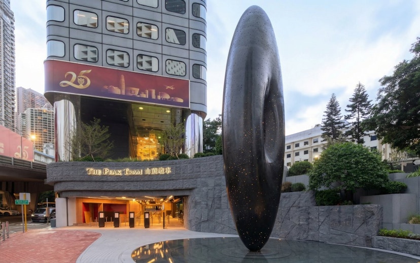 Entrance to The Peak Tram station in Hong Kong with modern sculpture.