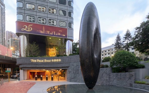 Entrance to The Peak Tram station in Hong Kong with modern sculpture.