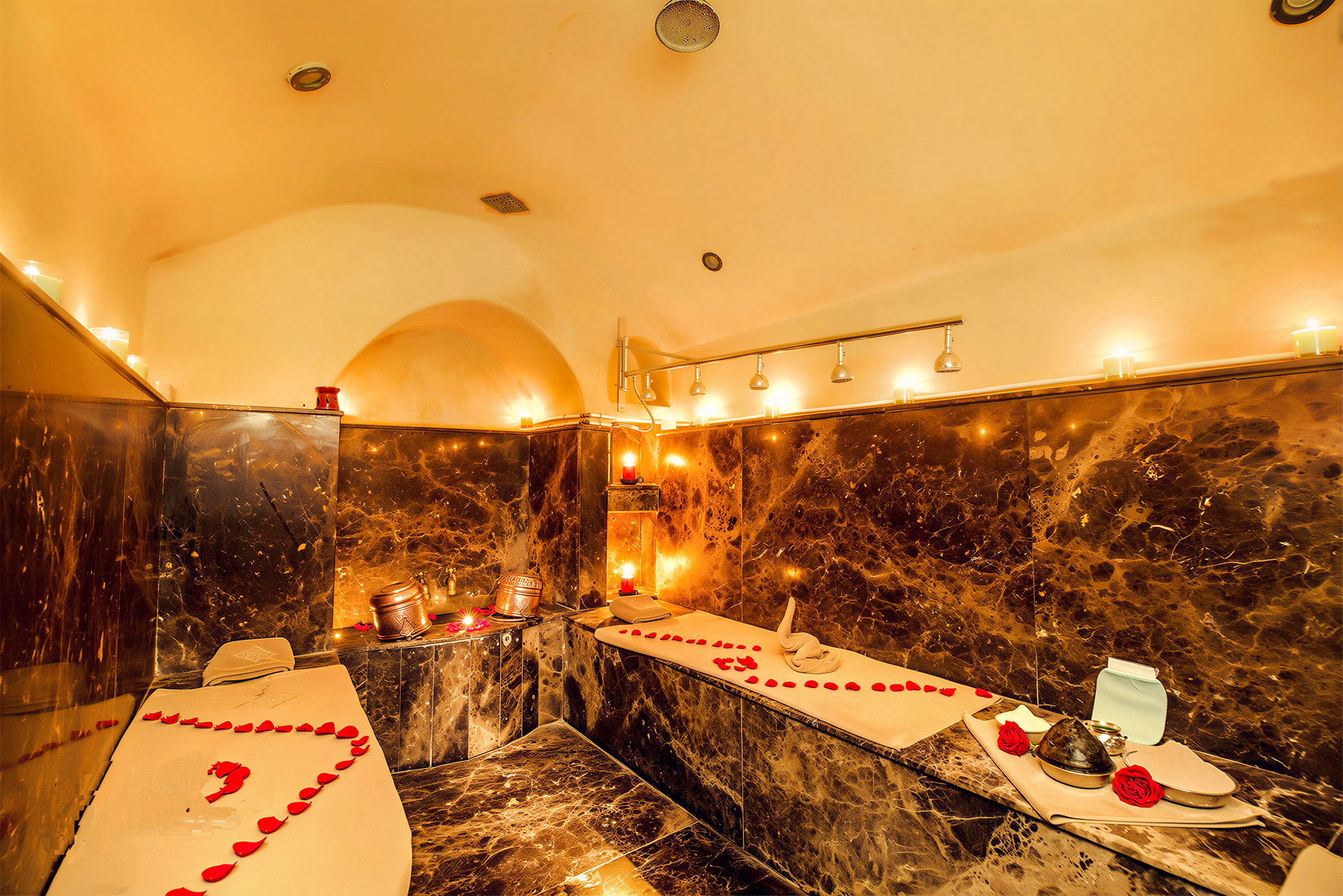 Luxurious Moroccan hammam with rose petals and candles in Marrakesh.