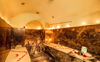 Luxurious Moroccan hammam with rose petals and candles in Marrakesh.