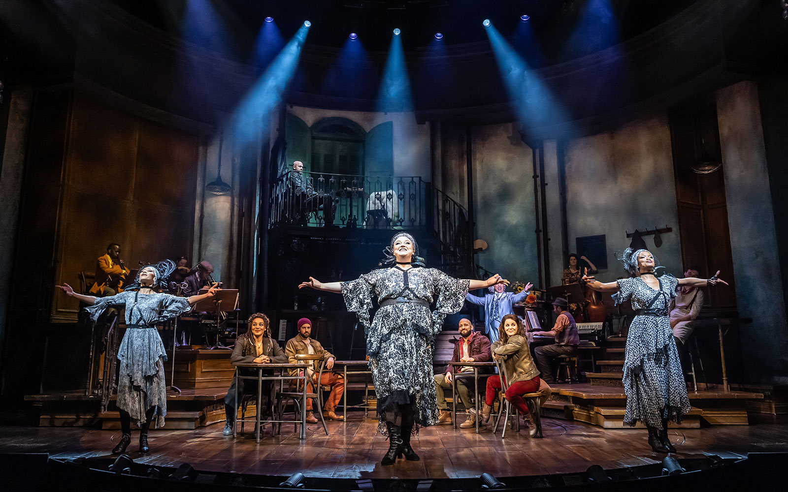 Performers on stage during Hadestown musical production.