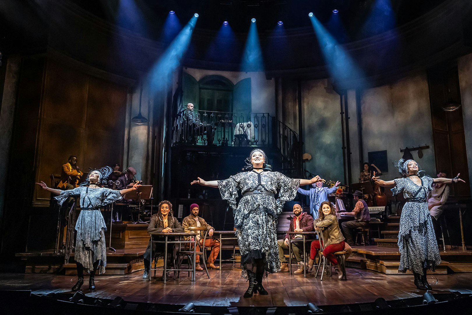 Performers on stage during Hadestown musical production.