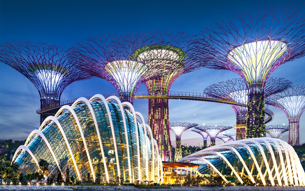 Gardens by the Bay Supertree Grove and Flower Dome in Singapore at dusk.