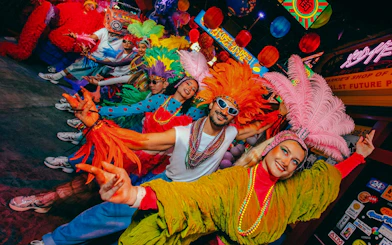 Colorful dancers in vibrant costumes at Electric Carnival, House of Hype.