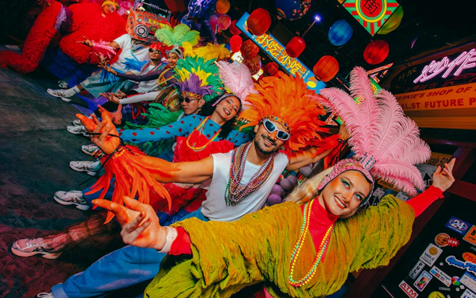 Colorful dancers in vibrant costumes at Electric Carnival, House of Hype.