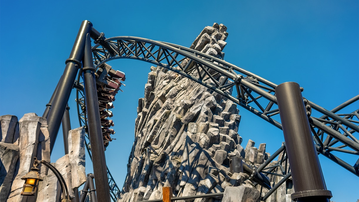 Taron launch coaster speeding through rocky terrain at Mystery theme park, Phantasialand, Germany.