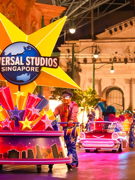 Universal Studios Singapore parade with performers and illuminated floats.