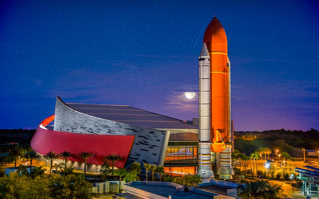 Kennedy Space Center rocket display at night, Orlando Explorer Pass.