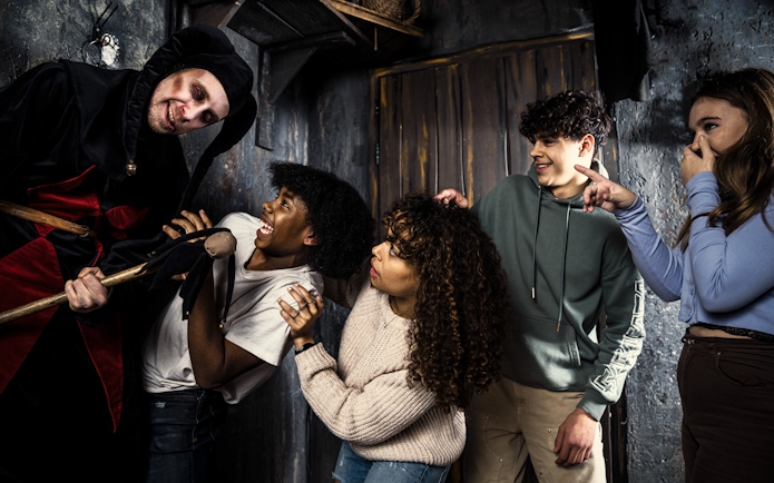 Visitors react to a costumed actor at the Amsterdam Dungeon.