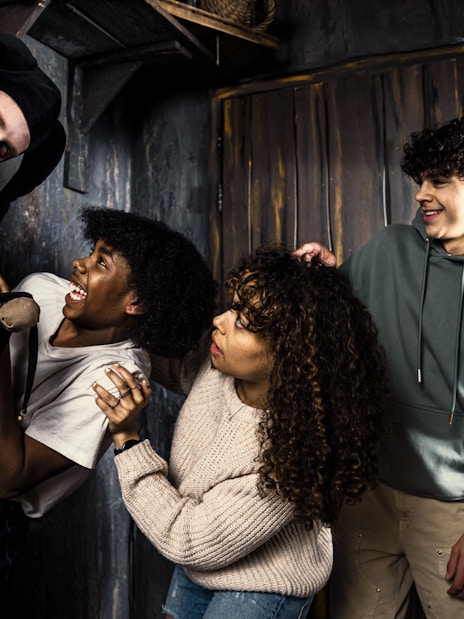Visitors react to a costumed actor at the Amsterdam Dungeon.