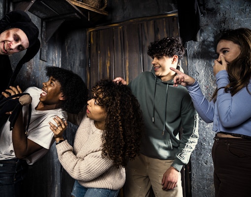 Visitors react to a costumed actor at the Amsterdam Dungeon.