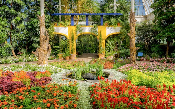 Colorful flower garden with archway inside New York Botanical Garden.