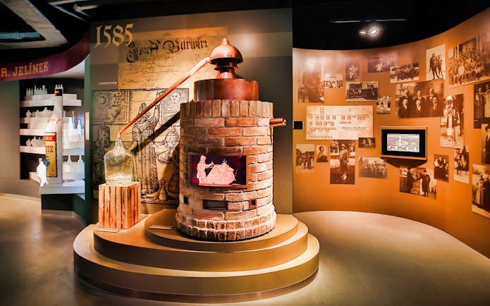 Slivovitz Museum exhibit with distillation equipment and historical photos.