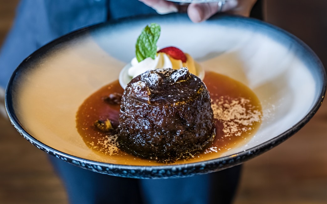Dessert served on Sunshine Coast Hinterland food and wine tour with caramel sauce and mint garnish.