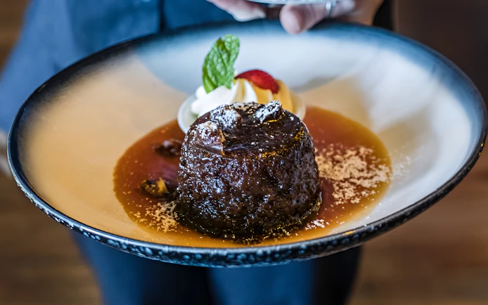 Dessert served on Sunshine Coast Hinterland food and wine tour with caramel sauce and mint garnish.